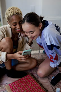 Two Girls Looking At Phone